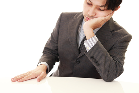 Tired Asian businessmanの写真素材