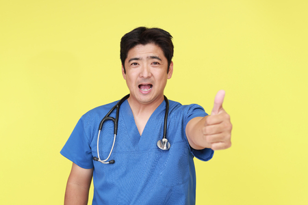 Doctor showing thumbs upの写真素材