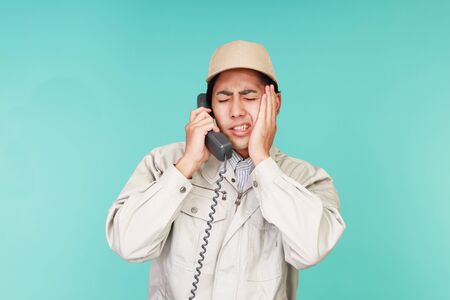 Tired and stressed Asian workerの写真素材