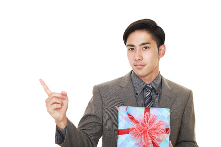 Smiling businessman with a giftの写真素材