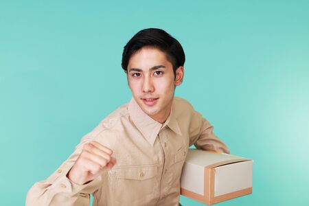 Delivery man doing victory gesture.の写真素材