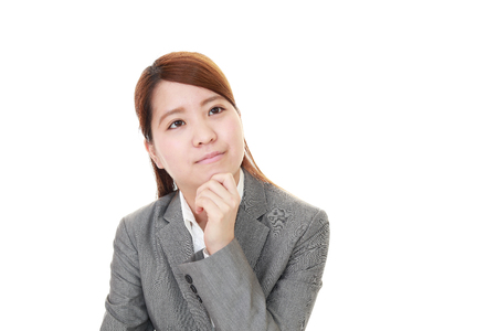 Uneasy Asian business womanの写真素材