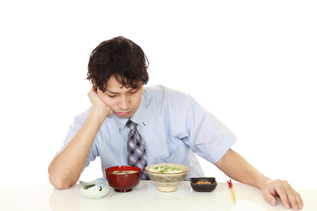 Portrait of Asian man no appetite while having foods.の写真素材