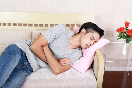 Man lying on a couchの写真素材