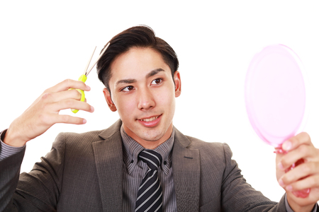 Man taking care of his hairの写真素材