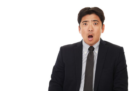 Surprised Asian businessmanの写真素材