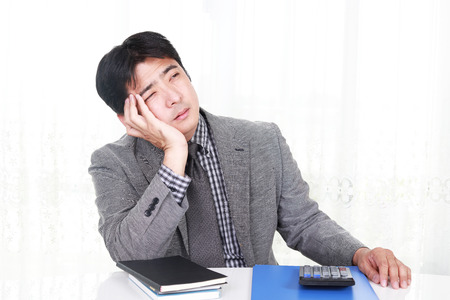Tired and stressed Asian businessmanの写真素材
