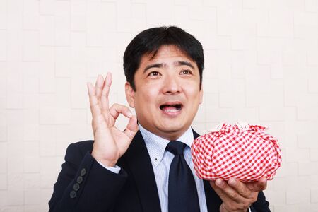 The male office worker who poses happilyの写真素材