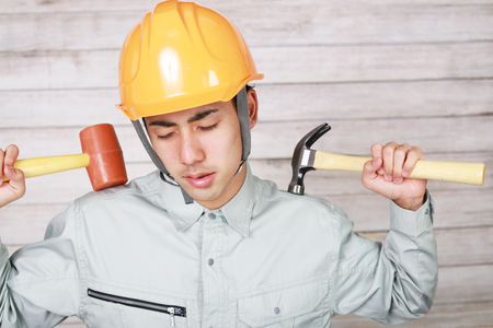 Tired and stressed Asian workerの写真素材