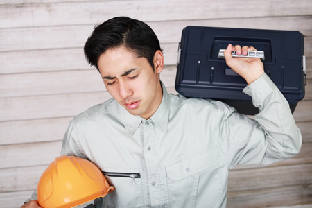 Tired and stressed Asian workerの写真素材