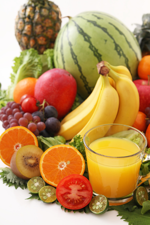 Fresh fruits with a glass of juiceの写真素材