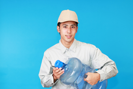 Worker with a container of waterの写真素材