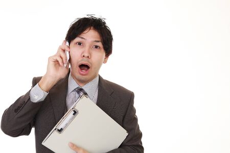 Surprised Asian businessmanの写真素材