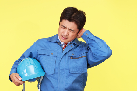 Tired and stressed Asian workerの写真素材