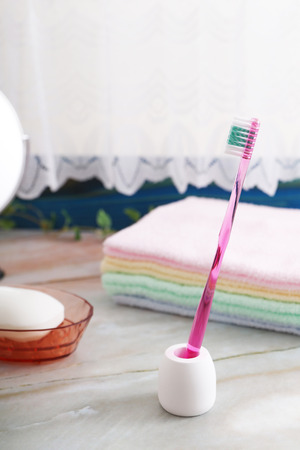 Pile of towels and toothbrushの写真素材