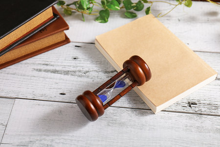 Books and sandglass on the table