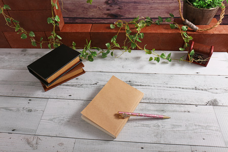Notebooks and pen on the deskの写真素材