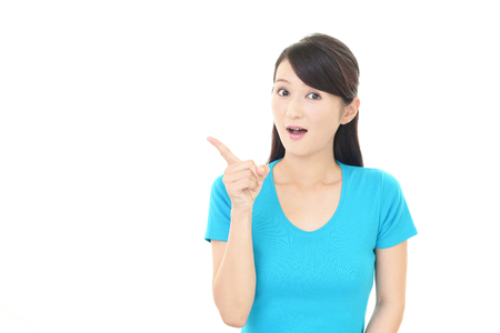 Asian woman pointing with her fingerの写真素材