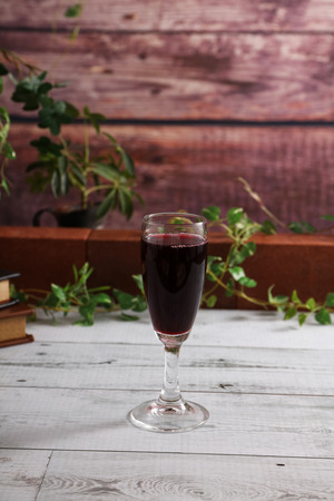 A glass of red wine on the tableの写真素材