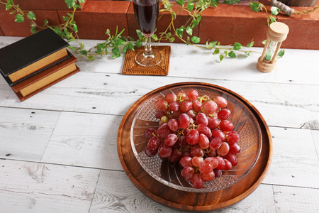 Fresh fruits and a glass of wineの写真素材