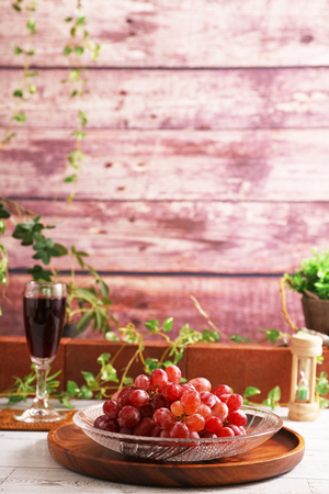 Fresh fruits and a glass of wineの写真素材