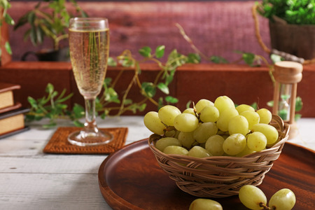 Fresh fruits and a glass of wineの写真素材