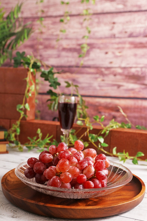 Fresh fruits and a glass of wineの写真素材