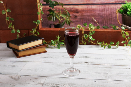 A glass of red wine on the tableの写真素材
