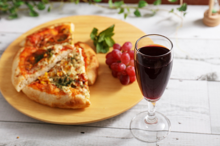 Delicious pizza and a glass of wineの写真素材