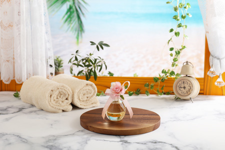 A bottle of perfume on a wooden trayの写真素材