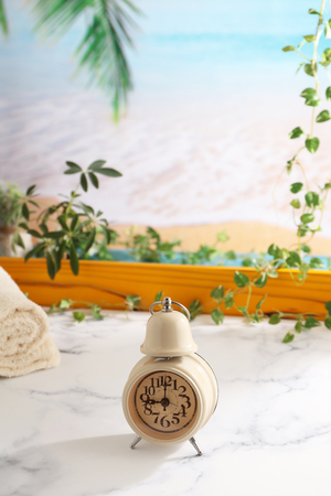 Old fashioned alarm clock on the tableの写真素材