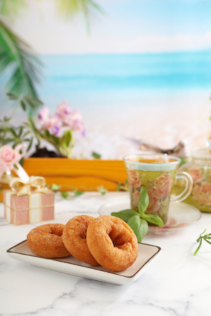 Delicious sweets and herbal tea on the dining tableの写真素材