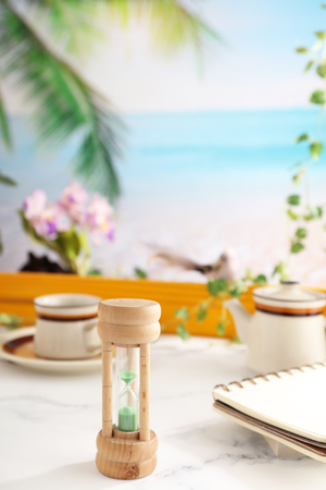 Classic wooden hourglass on the tableの写真素材