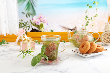 Delicious sweets and herbal tea on the dining tableの写真素材