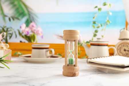 Classic wooden hourglass on the tableの写真素材