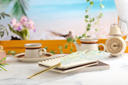 Notebooks and quill pen on the deskの写真素材