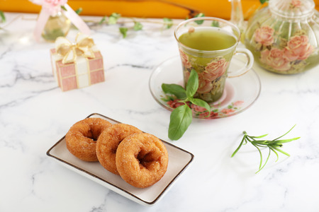 Delicious sweets and herbal tea on the dining tableの写真素材