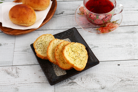 A cup of tea and breads on the dining tableの写真素材
