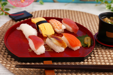 Delicious Japanese cuisine sushi on a wooden trayの写真素材