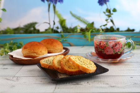 A cup of tea and breads on the dining tableの写真素材