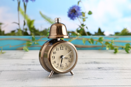 Old fashioned alarm clock on the tableの写真素材