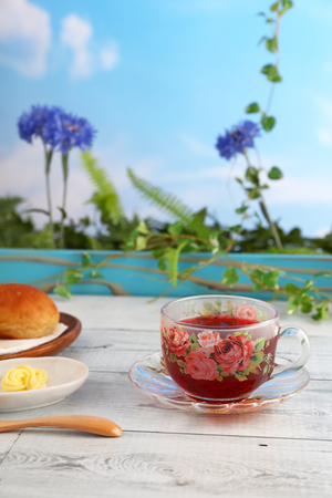 A cup of tea and breads on the dining tableの写真素材