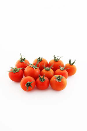 Fresh cherry tomatoes isolated on white backgroundの写真素材