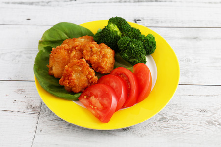 Delicious fried chicken in a dish on the dining tableの写真素材