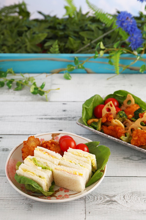 Tasty sandwiches and salad on the tableの写真素材
