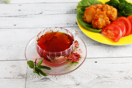 Delicious fried chicken and a cup of teaの写真素材