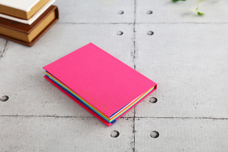 Notebook and books on the deskの写真素材