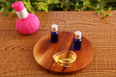 Herbal hot compress ball and essential oilsの写真素材