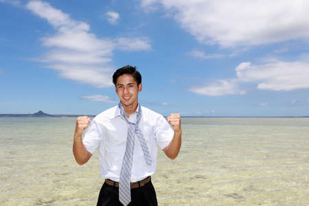 Smiling Asian man on the beach.の写真素材