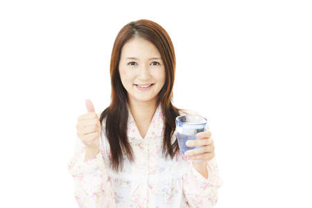 Woman drinking a glass of water.の写真素材